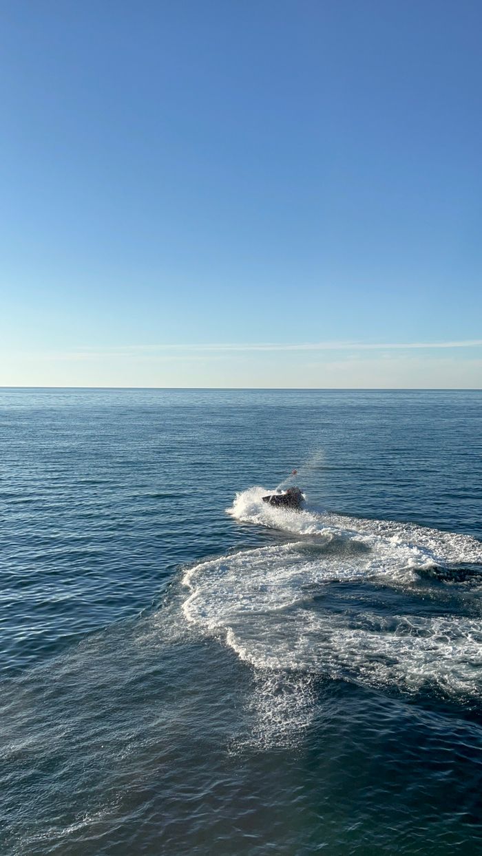 Exciting jet ski ride creating waves on the Black Sea in Batumi, Georgia during summer.