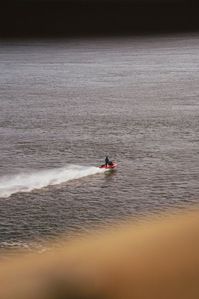 services-03 A person enjoying a ride on a jet ski on a river in Québec, Canada.